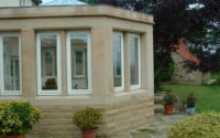 A photo from a recently completed BBS project, titled 'Natural Stone Walling and Masonry for Conservatory in Scotton, North Yorkshire'